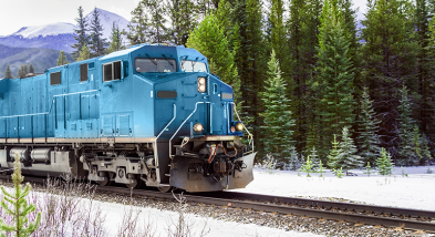 Blue locomotive in winter in the forest