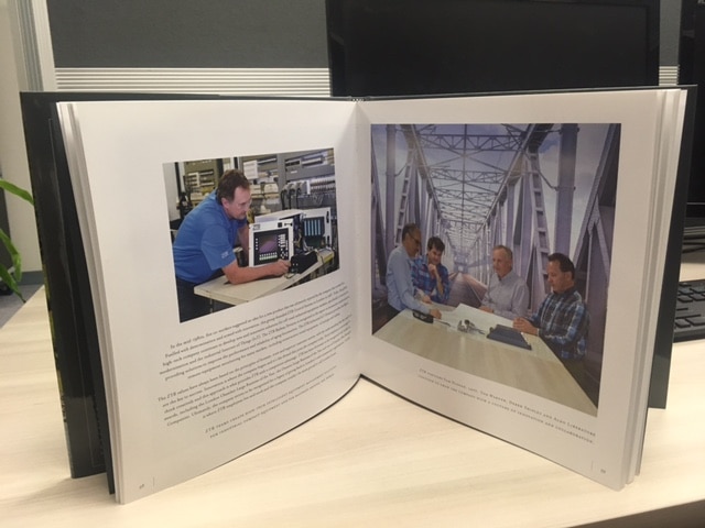 Open book with office and bridge photos.