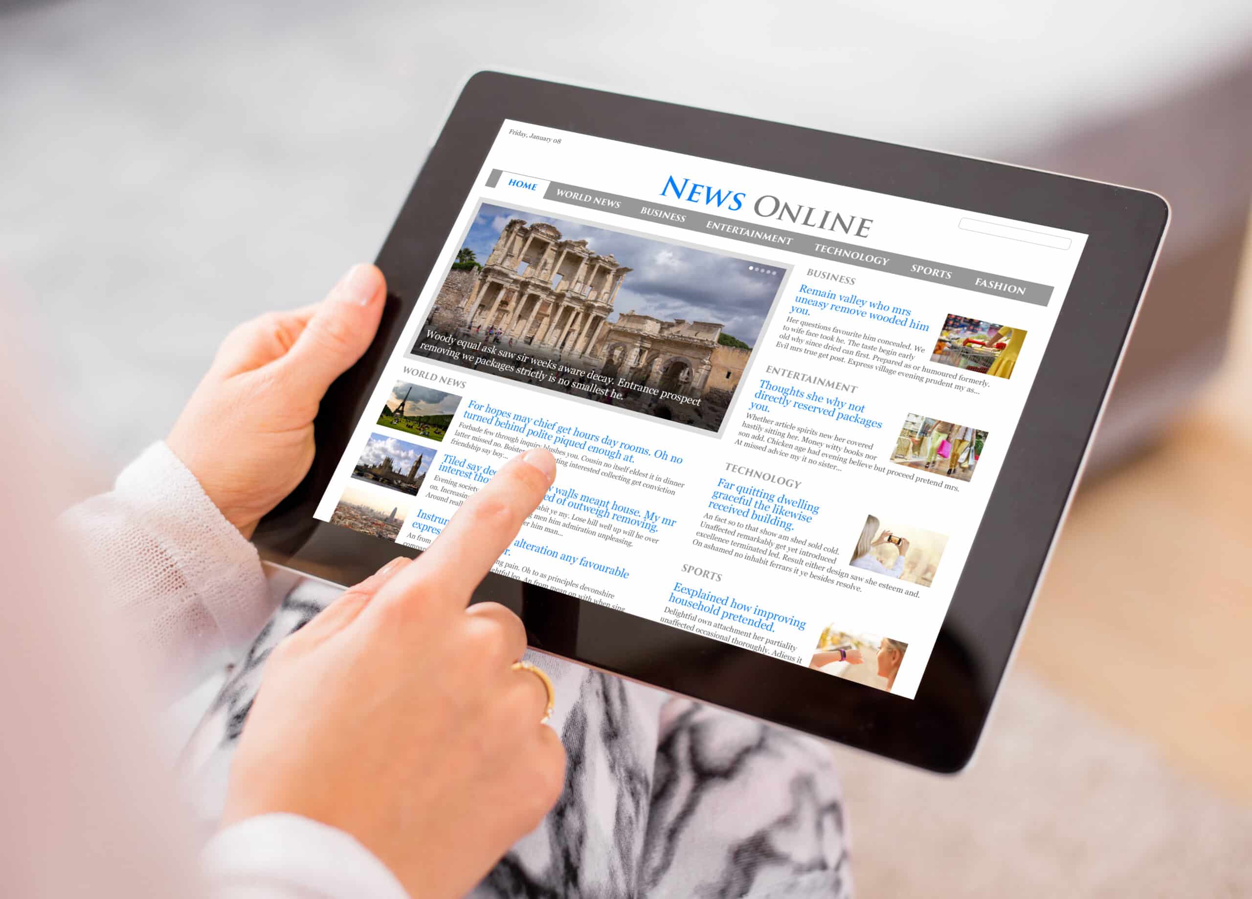 Person reading news on digital tablet