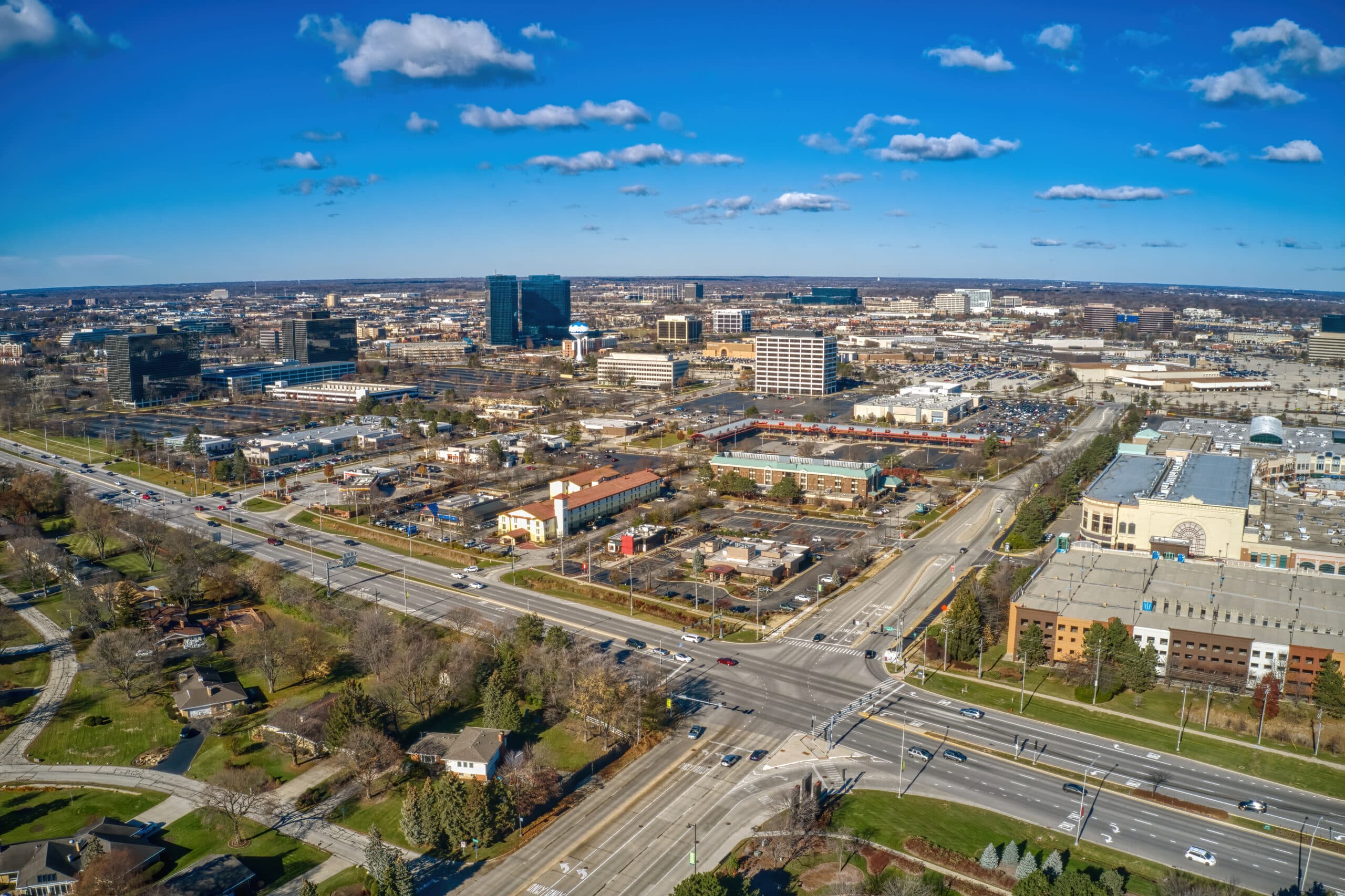 Aerial view of a cityscape under blue sky.