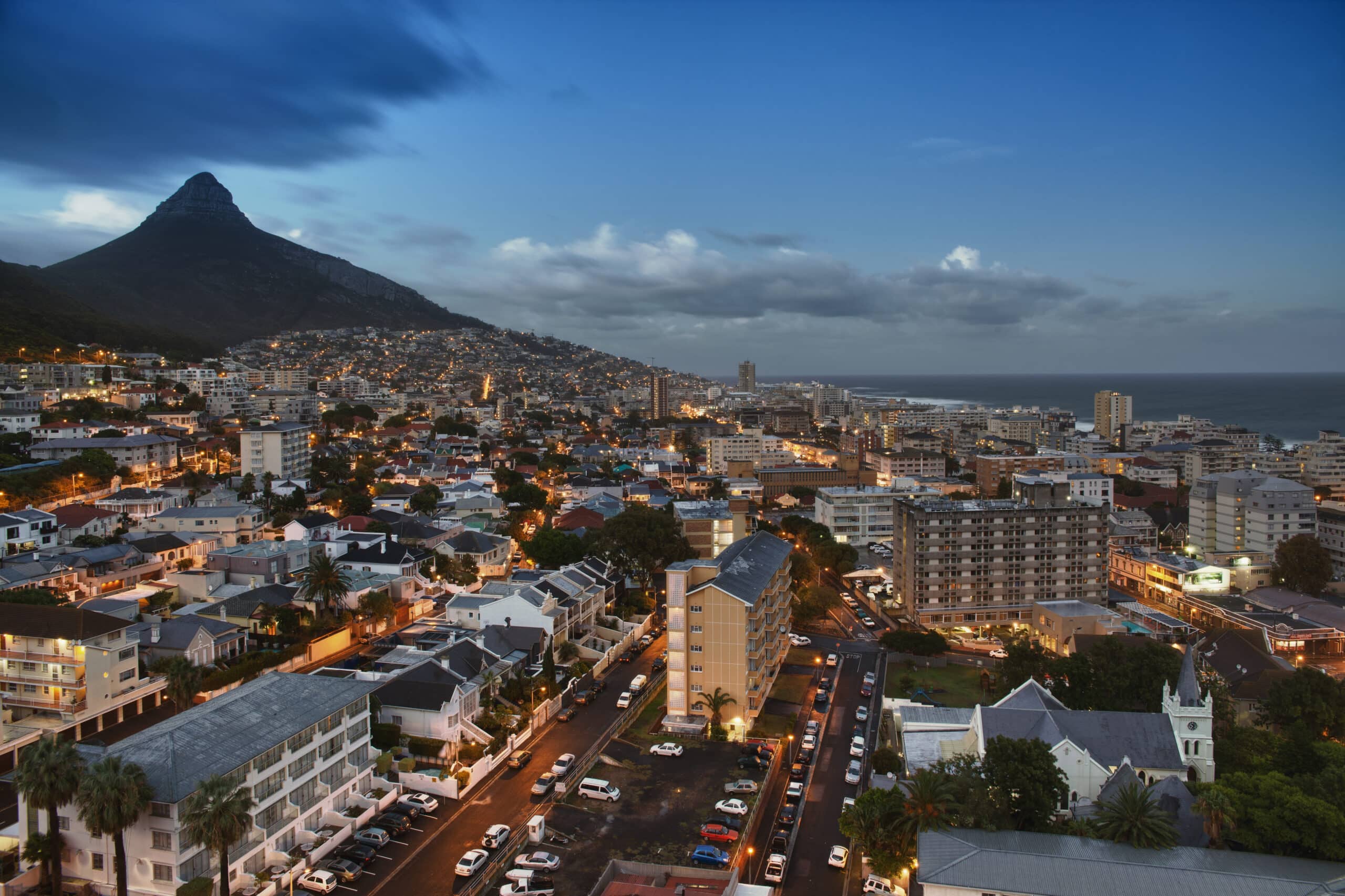 Cape Town cityscape at dusk with mountain view.