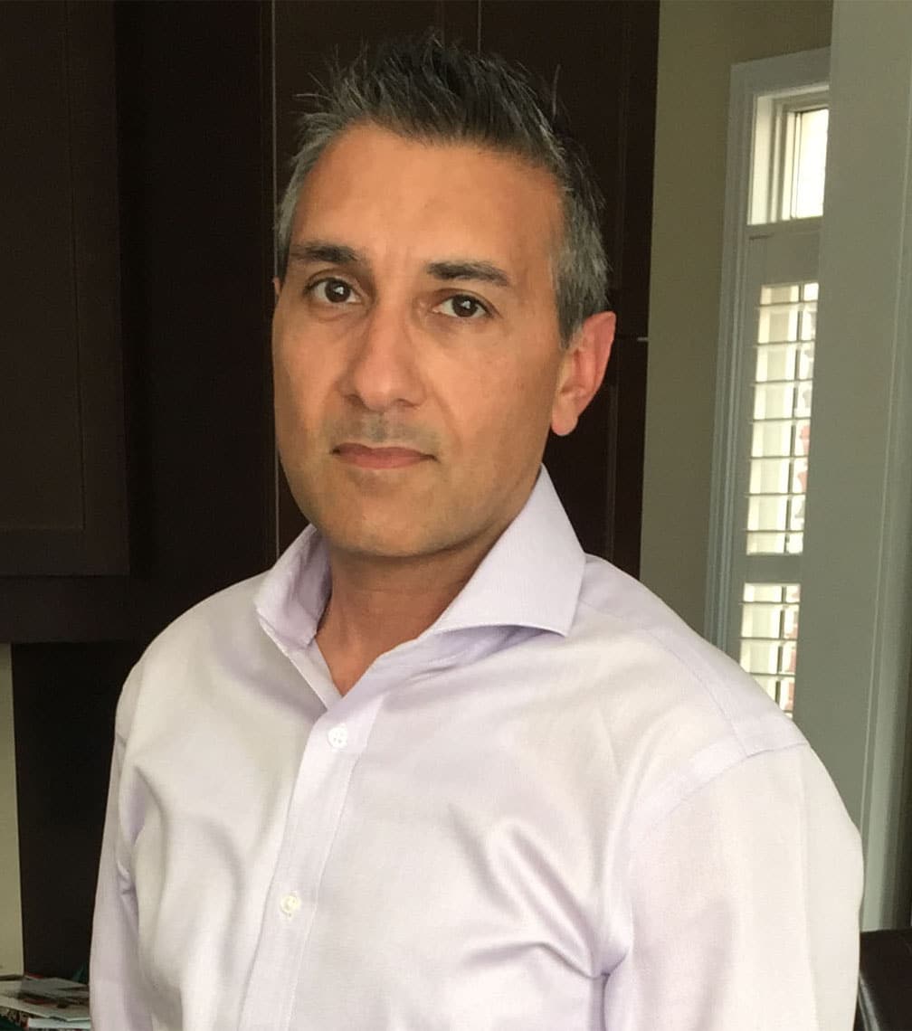 Person in a light shirt standing indoors.