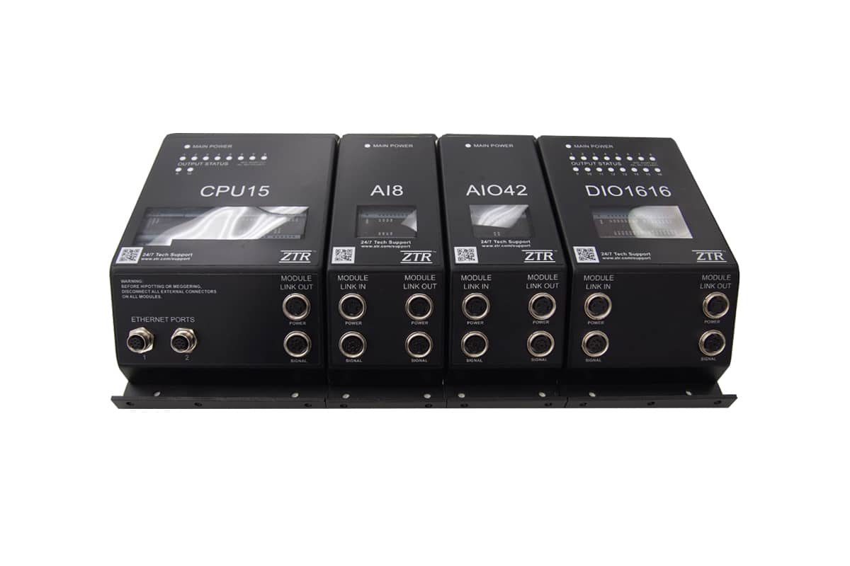 Four black electronic control modules in a row.