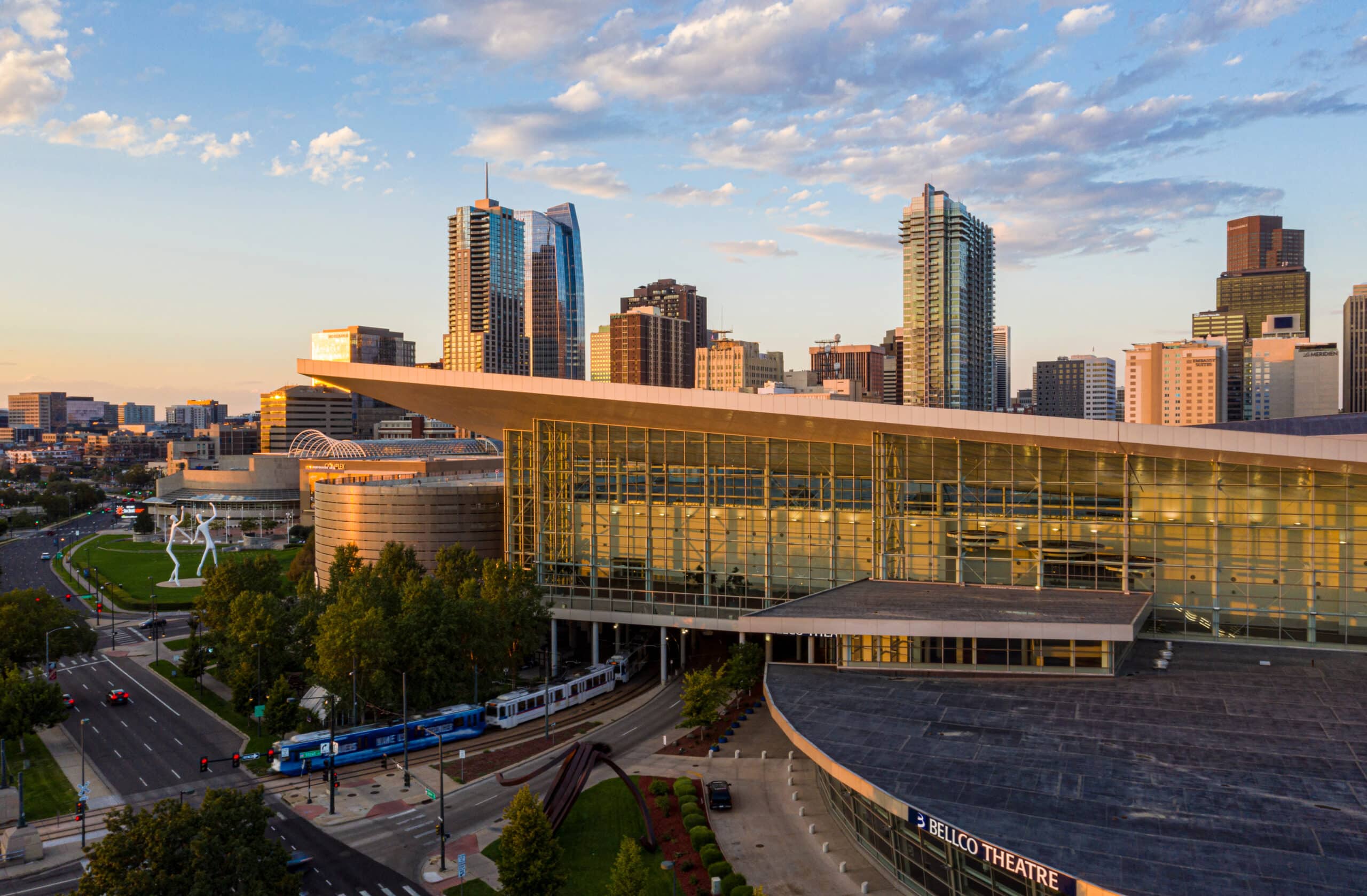 Denver cityscape with Bellco Theatre at sunset