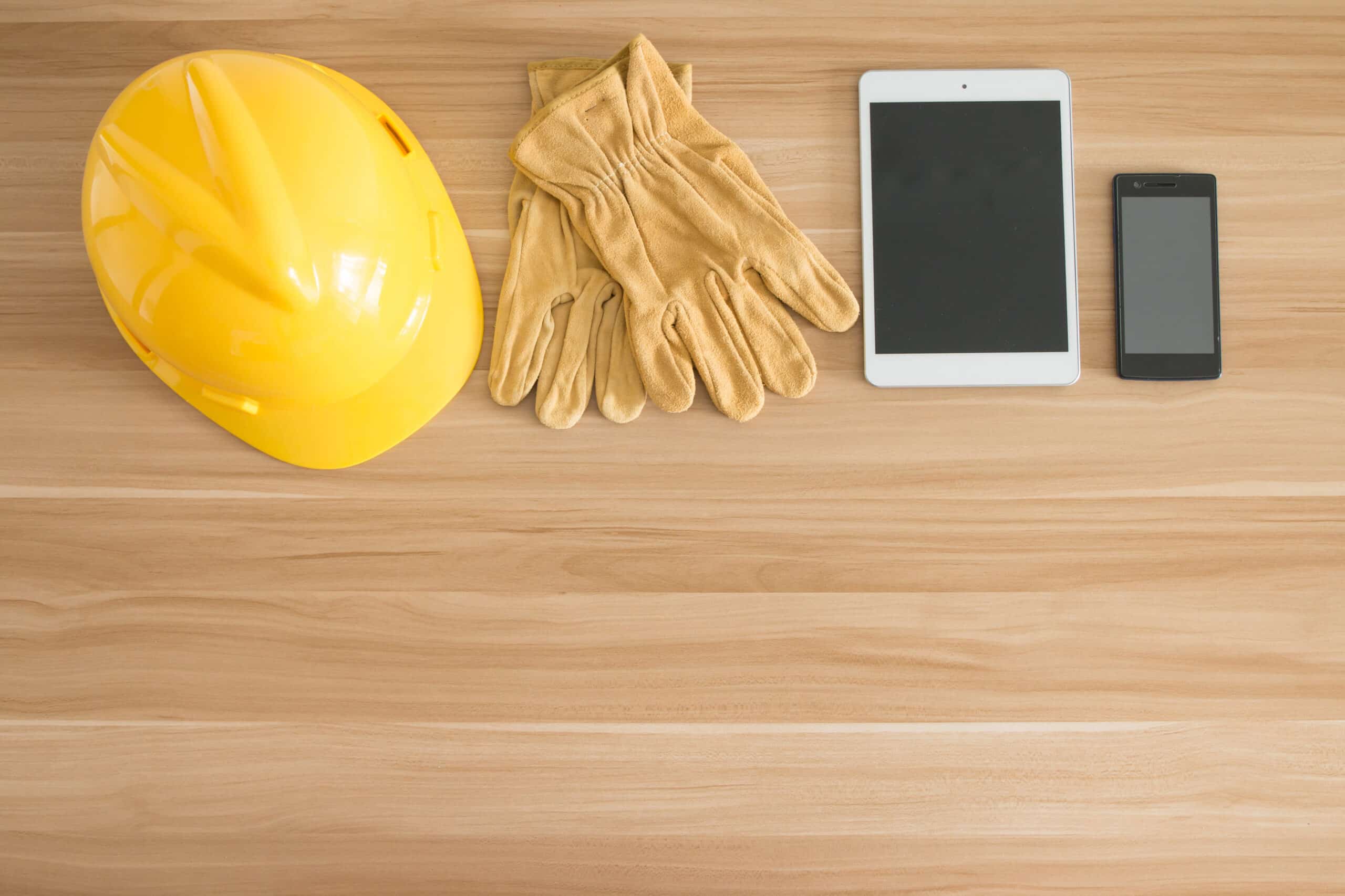Construction safety gear with tablet and smartphone.