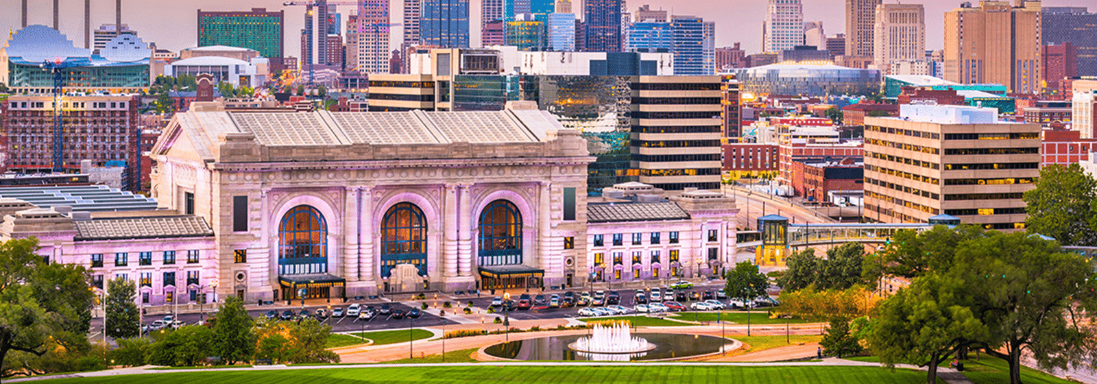 Historic train station with city skyline background.
