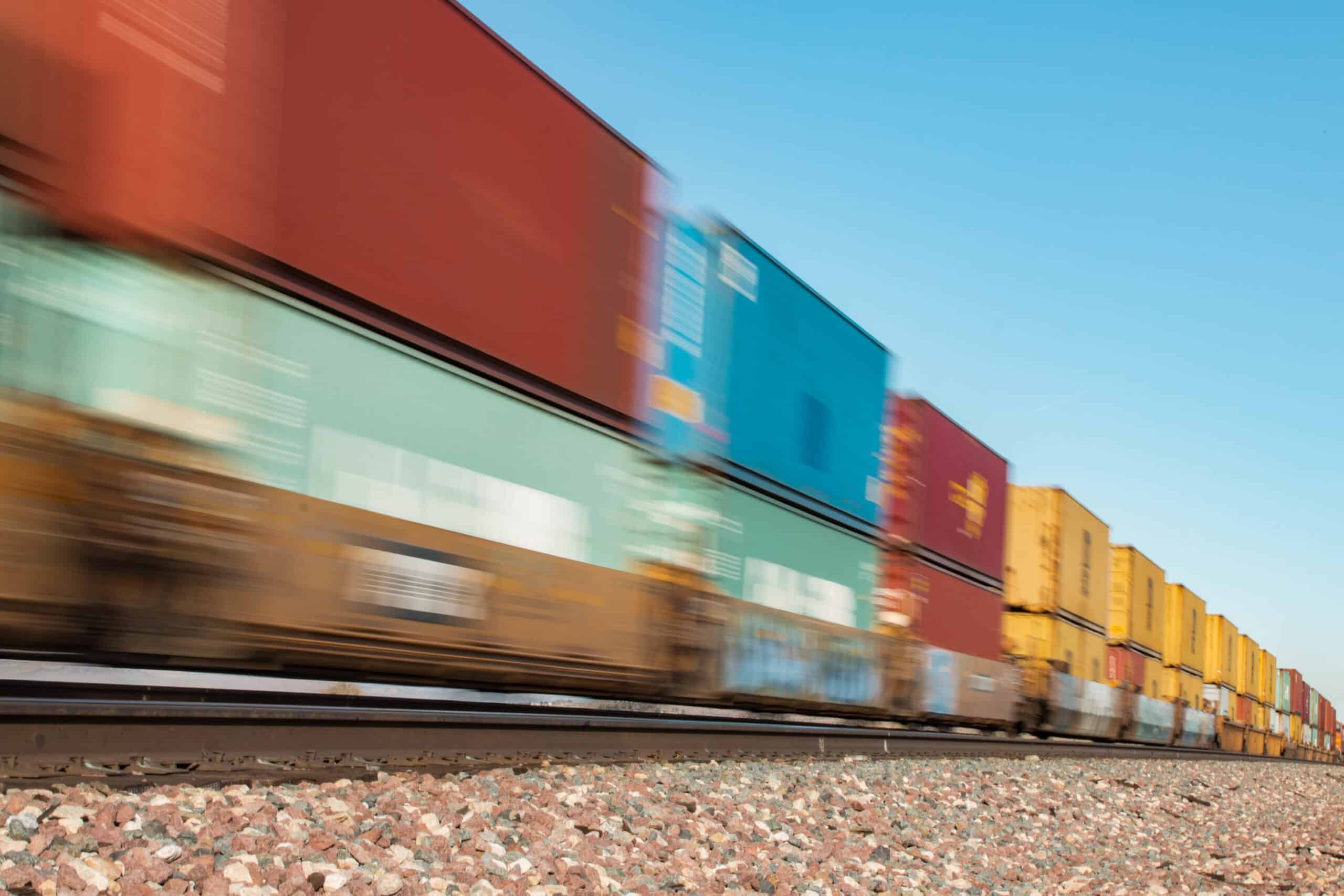 Speeding freight train with colorful containers